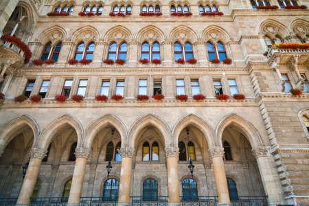 part of the Rathaus in Vienna with windows decorated with flowersの写真素材