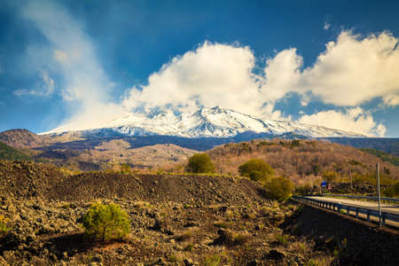 rural landscape and snowy volcano Etna smoking, Sicilyの写真素材
