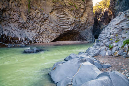 lazy river and unusual rocks at Alcantara Gorge - geological and botanical park at Sicily, Italyの写真素材