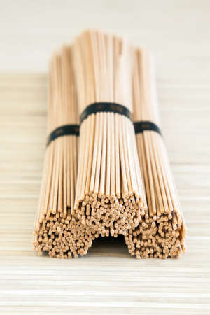 close-up three dried stacked bundles of buckwheat soba noodlesの写真素材