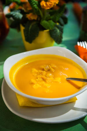 bowl with pumpkin soup served with croutonsの写真素材