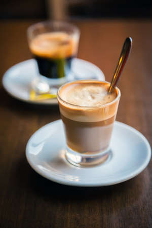 close-up two glasses of coffe - espresso and macchiatoの写真素材