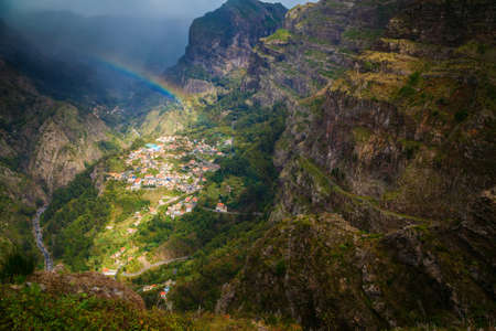small village Curral das Freiras with a rainbow above, Madeira island, Portugal