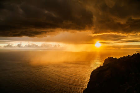 impressive view of the storm dark clouds at sunset above the Atlantic ocean, Madeiraの写真素材
