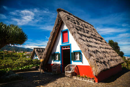 traditional small-thatched triangular Madeira house, built of wood and thatched with strawの写真素材