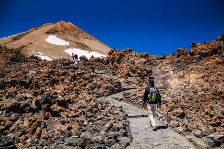 man going to the top of the volcano Teide in Tenerife, Canary Islands, Spainの写真素材