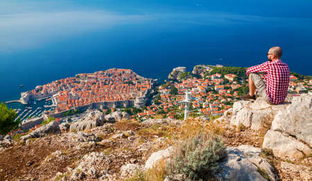 man enjoying the beautiful town of Dubrovnik from above, Croatiaの写真素材