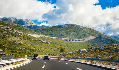 picturesque road leading up to the mountains in Croatiaの写真素材