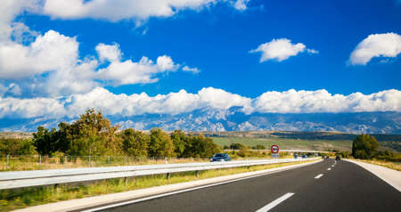 picturesque road with mountains in a distance somewhere in Croatia