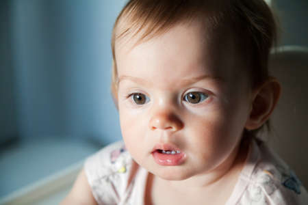 closeup portrait of cute baby girl with big eyes