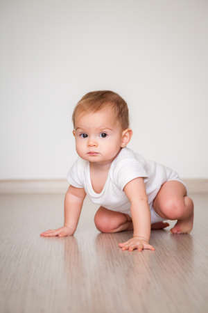 little baby girl crawling on the floorの写真素材