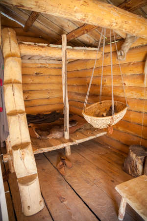 bedroom in the old peasant log cabin - a hanging stage and a bed with furの写真素材