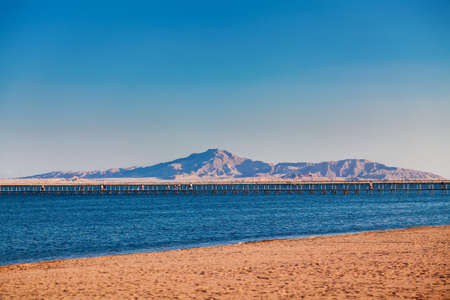 beach and pier with the mountains on a background, Red sea, Egypt