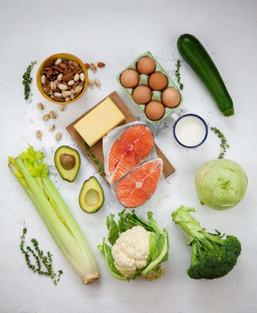 Keto diet concept. A set of products of the healthy balanced food. Green vegetables, avocado, nuts,...