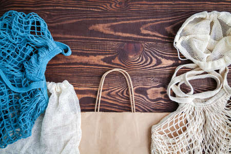 Various textile and paper eco bags on wooden background. Eco friendly, reuse and zero waste concept.の写真素材