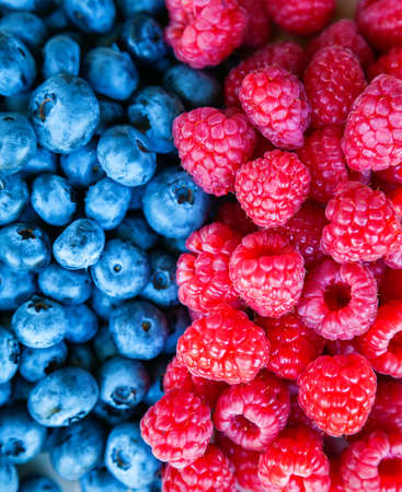 Close-up tasty ripe fresh summer berries - raspberry and blueberryの写真素材