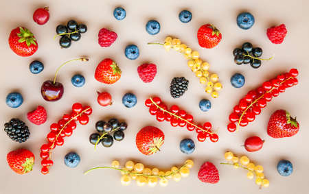 Tasty different ripe fresh summer berries on a neutral backgroundの写真素材