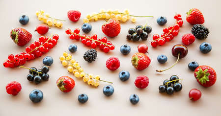 Various ripe fresh summer berries on a neutral backgroundの写真素材