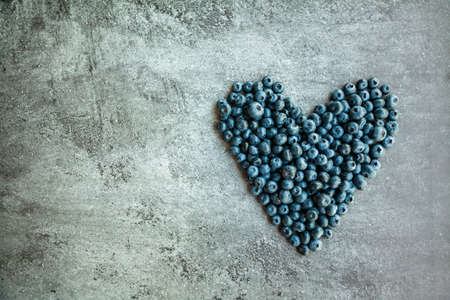 Heart shaped blueberries on a gray concrete background with copy-spaceの写真素材