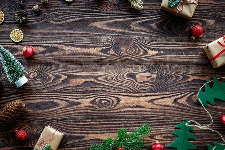 Christmas composition with gift boxes, pine cones and decorations on a wooden rustic background. Copy-space, flat lay.の写真素材