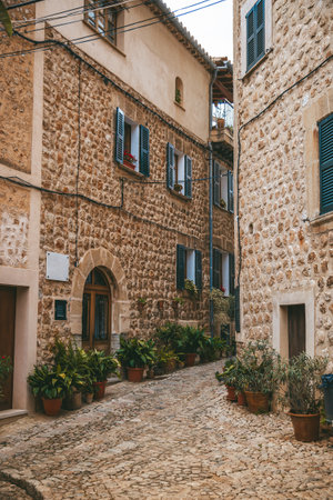 Charming village street with historic stone houses in Fornalutx, Mallorcaの写真素材