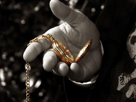 Black and white of man's hand with colorized pocket watchの写真素材