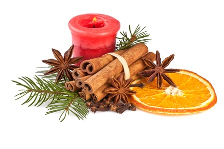 christmas decoration with fir branch, candle, cinnamon on whiteの写真素材
