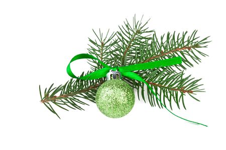 green christmas ball with fir branch on whiteの写真素材