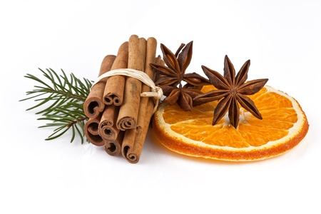 orange slice, cinnamon with fir branch isolated on whiteの写真素材