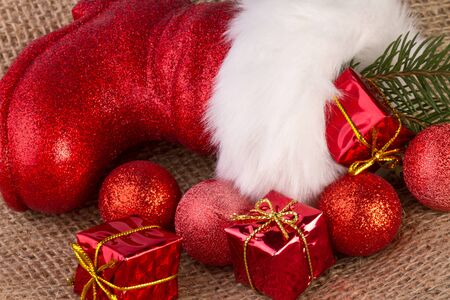 santa claus boots with gifts on jute backgroundの写真素材