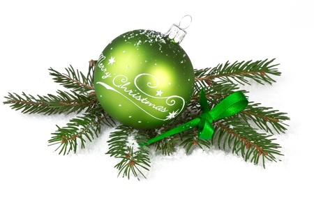green christmas ball with fir branch on white backgoundの写真素材