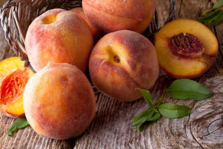 fresh peaches on wood  backgroundの写真素材