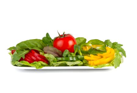 cut vegetables on plate, isolated  on white の写真素材