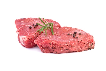 raw beef steak with green herbsの写真素材