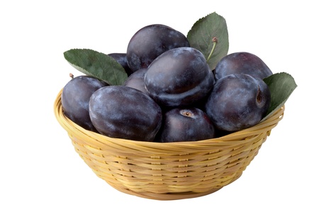 plums in basket, isolated on white backgroundの写真素材