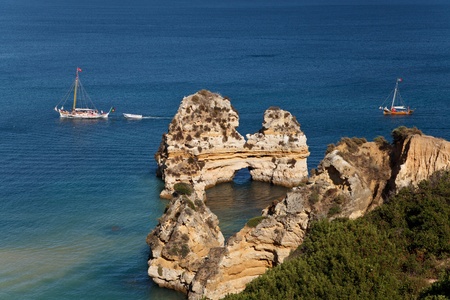 two boats on blue sea, sandstone cliffsの写真素材
