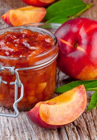 nectarine, peach jam on wood background の写真素材