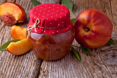 nectarine, peach jam on wood backgroundの写真素材
