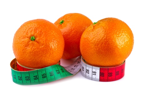 diet concept, tangerine and measure tape isolated on white background の写真素材