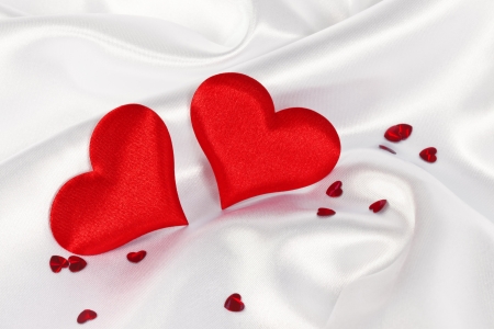two red heart on white silk の写真素材