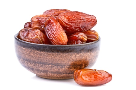 dried dates in brown cup isolated on whiteの写真素材