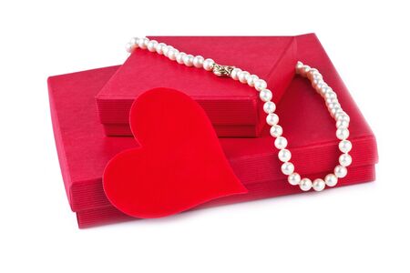 gift box with red heart and pearl necklace isolated on whiteの写真素材