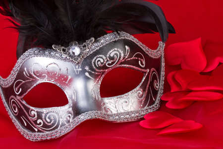 venetian mask and hearts on red backgroundの写真素材
