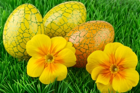 Easter colored eggs on the green grassの写真素材