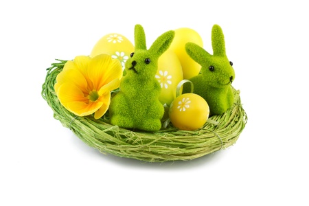 easter bunny with easter eggs in nest isolated on whiteの写真素材