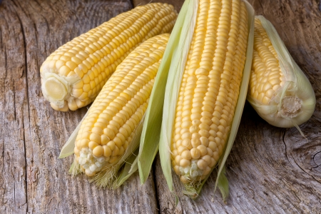 corn cob on old wooden backgroundの写真素材