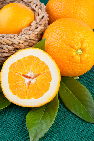 Orange fruits over green canvas fabricの写真素材