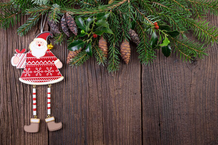 Santa Claus with Fir Branch over Wooden Backgroundの写真素材