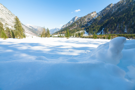 Snow fall early winter and late autumn. Alps landscape with snow capped mountains in the late autumn season.の写真素材