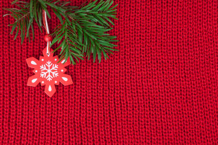Christmas winter background of red wool knitted fabric with decorationの写真素材